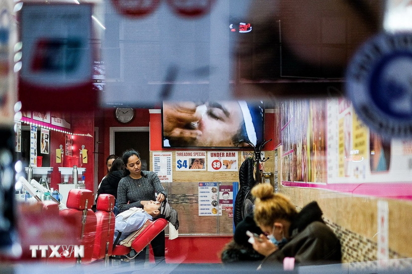 Nhân viên làm việc tại một tiệm làm tóc ở New York (Mỹ). (Ảnh: THX/TTXVN)