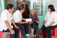 Lãnh đạo Đảng ủy, HĐND, UBND, Ủy ban MTTQ Việt Nam phường Phú Lợi trao quà tặng của Đảng, Nhà nước nhân dịp chào mừng Đại hội đại biểu toàn quốc lần thứ XIV của Đảng và Tết Nguyên đán Bính Ngọ năm 2026, cho người được thụ hưởng tại nhà. (Ảnh: Huyền Trang/TTXVN)