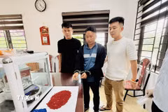 Đối tượng Sùng Quáng Dình (SN 1992, trú bản Huổi Lụ 2, xã Nà Hỳ, tỉnh Điện Biên) cùng tang vật tại cơ quan Công an. (Ảnh: TTXVN phát)