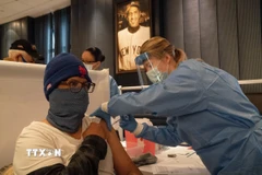 Nhân viên y tế tiêm vaccine phòng COVID-19 cho người dân tại New York, Mỹ. (Ảnh: THX/TTXVN)