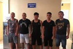 Quang ''Rambo'' (thứ 2 từ trái qua) cùng đồng phạm tại cơ quan công an. (Ảnh: Công an cung cấp)