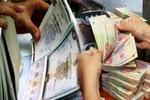 Lãi suất trúng thầu trái phiếu Chính phủ do Kho bạc Nhà nước phát hành tại những phiên cuối cùng trong tháng Ba của kỳ hạn 5 năm, 7 năm, 10 năm và 15 năm lần lượt là 1,47%, 2,02%, 2,42% và 2,62%. (Ảnh: Vietnam+)