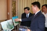 Chủ tịch UBND Thành phố Hồ Chí Minh Nguyễn Thành Phong và Tổng Giám đốc Điều hành Công ty Lotte Asset Development Lee Kwang Young trao đổi về phối cảnh dự án. (Ảnh: Tiến Lực/TTXVN)