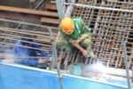 Trên công trường thi công tuyến đường sắt Cát Linh-Hà Đông vẫn diễn ra tình trạng công nhân thiếu mũ bảo hiểm, không sử dụng găng tay, kính hàn khi lao động. (Ảnh: Anh Tuấn/TTXVN)