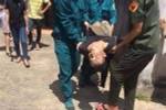 Thanh niên nghi ngáo đá đang được đưa lên bệnh viện. (Ảnh: TTXVN phát)