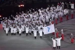Tại lễ khai mạc Olympic PyeongChang 2018 ngày 9/2, đoàn vận động viên Hàn Quốc và Triều Tiên đã cùng diễu hành chung dưới lá cờ thống nhất. (Nguồn: AFP/TTXVN)
