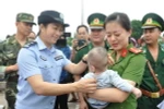 Lực lượng chức năng Việt Nam tiếp nhận em bé bị bán sang Trung Quốc. (Ảnh:Nguyễn Hoàng/TTXVN)