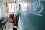 Vệ sinh, khử khuẩn phòng học, bàn ghế tại Trường THPT Trần Phú, quận Hoàn Kiếm. (Ảnh: Thanh Tùng/TTXVN)