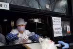 Cửa hàng bánh bao dùng ván gỗ đưa hàng cho khách. (Ảnh: Reuters)