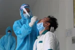 Thực hiện lấy mẫu xét nghiệm trong buổi diễn tập. (Ảnh: Hồng Thái/TTXVN)