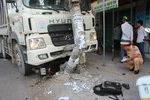 Chiếc xe “điên” sau khi cuốn 2 xe gắn máy vào gầm tiếp tục đâm gãy hai trụ điện bên đường. (Ảnh: Sỹ Tuyên/TTXVN)