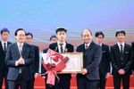 Thủ tướng Nguyễn Xuân Phúc, Chủ tịch Hội đồng Thi đua-Khen thưởng Trung ương trao tặng Huân chương lao động hạng Nhất cho em Bùi Hồng Đức, học sinh lớp 12, Trường THPT chuyên Khoa học Tự nhiên, trường Đại học Tự nhiên, Đại học Quốc gia Hà Nội. (Ảnh: Thống