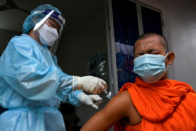 Nhân viên y tế tiêm vaccine ngừa COVID-19 cho nhà sư tại Phnom Penh, Campuchia. (Ảnh: AFP/TTXVN) Campuchia cấp phép sử dụng khẩn cấp vaccine Sputnik V của Nga ảnh 1