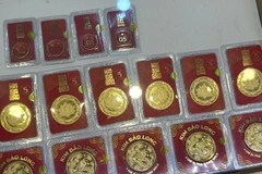 Giá vàng trong nước tăng giảm trái chiều nhau, tỷ giá trung tâm tăng nhẹ. (Ảnh: Vietnam+)