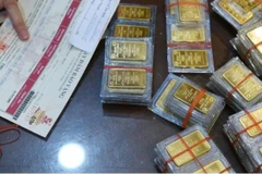 Giá vàng trong nước giao dịch quanh mức 156,4 triệu đồng mỗi lượng. (Ảnh: Vietnam+)