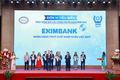 Ông Nguyễn Hướng Minh - Phó Tổng Giám đốc Eximbank (đứng giữa) nhận giải thưởng từ Ban tổ chức. (Ảnh: Vietnam+)