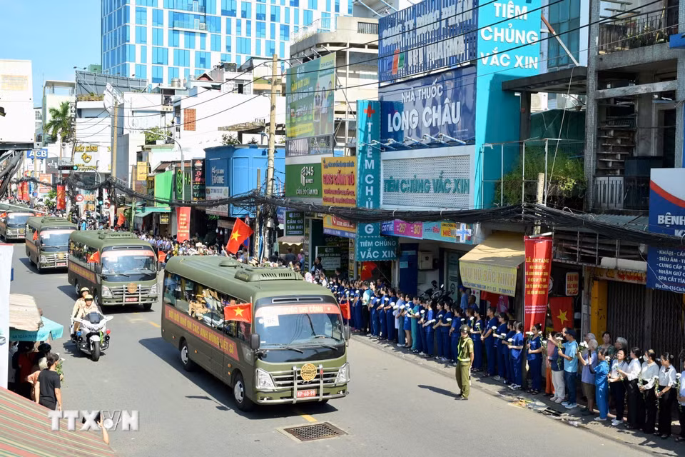 Đông đảo các tầng lớp nhân dân Thành phố Hồ Chí Minh đứng dọc hai bên đường tưởng nhớ, tri ân các Anh hùng liệt sỹ khi đoàn xe đưa hài cốt về an táng tại Nghĩa trang Liệt sỹ Thành phố. (Ảnh: Đinh Hằng/TTXVN)