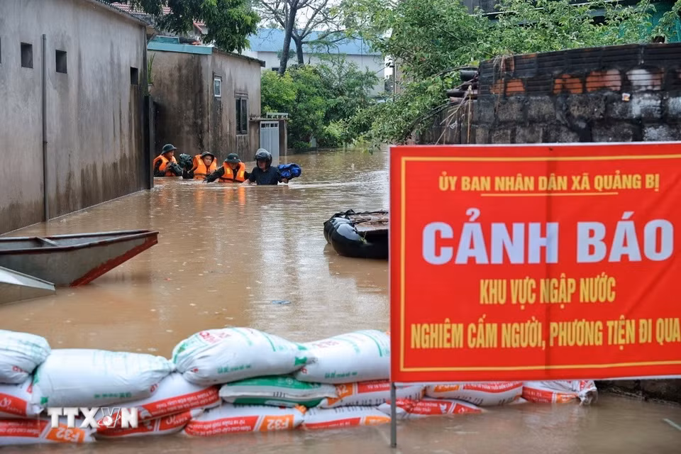 Cán bộ, chiến sỹ Trung đoàn 102, Sư đoàn 308 làm nhiệm vụ tại khu vực bị ngập sâu. (Ảnh: Phạm Tuấn Anh/TTXVN)