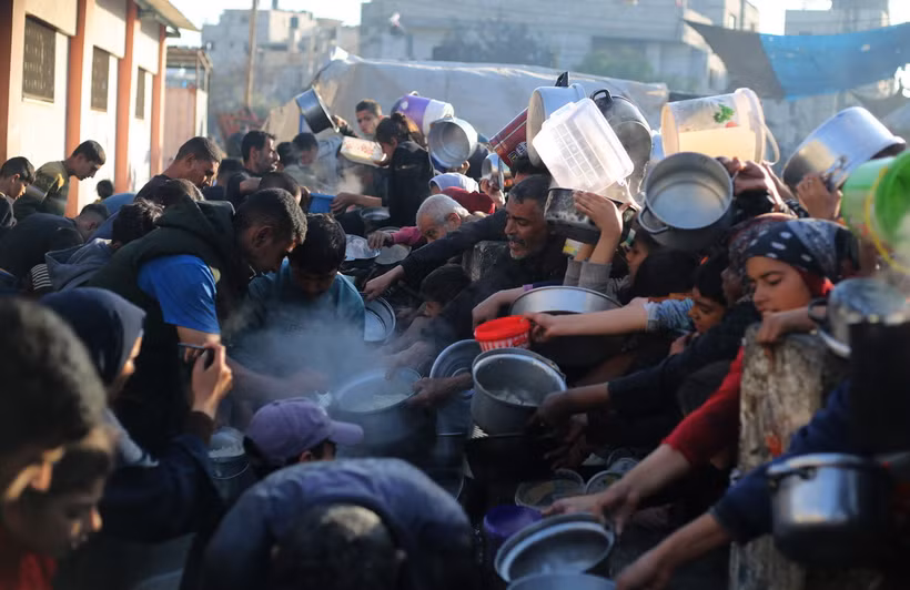 Người dân xếp hàng chờ được phát thức ăn cứu trợ tại Rafah, Dải Gaza, ngày 14/3/2024. (Ảnh: THX/TTXVN)