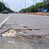 Đường ĐT.741 xuất hiện nhiều "ổ voi, ổ gà" gây nguy hiểm cho người đi đường. (Ảnh: Đậu Tất Thành/TTXVN)