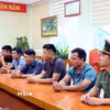 Các đối tượng được triệu tập đến làm việc tại cơ quan công an. (Ảnh: Công Tường/TTXVN)