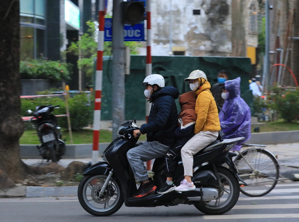 Phụ huynh và học sinh trong cái lạnh dưới 10 độ C sáng 23/1. (Ảnh: Hoàng Hiếu/TTXVN)