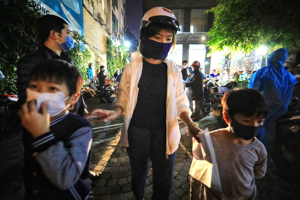 3 mẹ con đã khai báo y tế vui mừng khi được ra khỏi tòa nhà. (Ảnh: Thành Đạt/TTXVN)