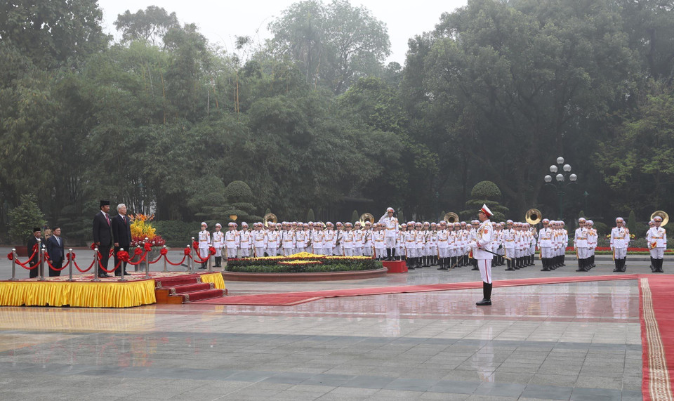 Tổng Bí thư, Chủ tịch nước Nguyễn Phú Trọng và Quốc vương Brunei Hassanal Bolkiah nghe Đội trưởng Đội danh dự Quân đội nhân dân Việt Nam báo cáo. (Ảnh: Trí Dũng/TTXVN)