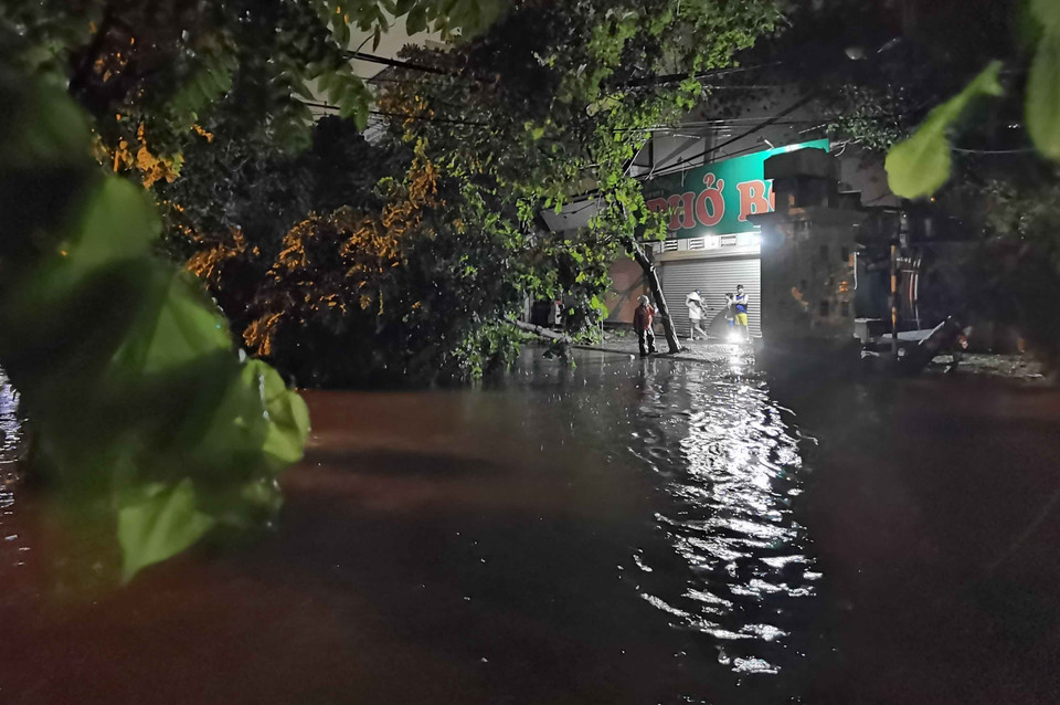 Người dân lội nước về nhà. (Ảnh: Thanh Tùng/TTXVN)