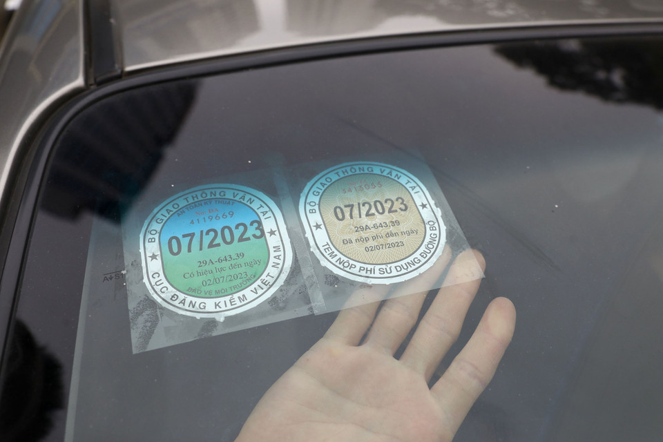 Dán thẻ đăng kiểm sau khi hoàn thành khám xe tại Trung tâm Đăng kiểm 29-03V. (Ảnh: Huy Hùng/TTXVN)