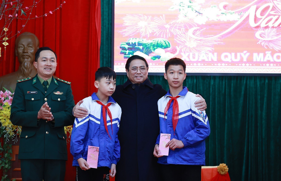Thủ tướng Phạm Minh Chính tặng quà cho các cháu là con nuôi của Đồn Biên phòng Tà Lùng. (Ảnh: Dương Giang/TTXVN)