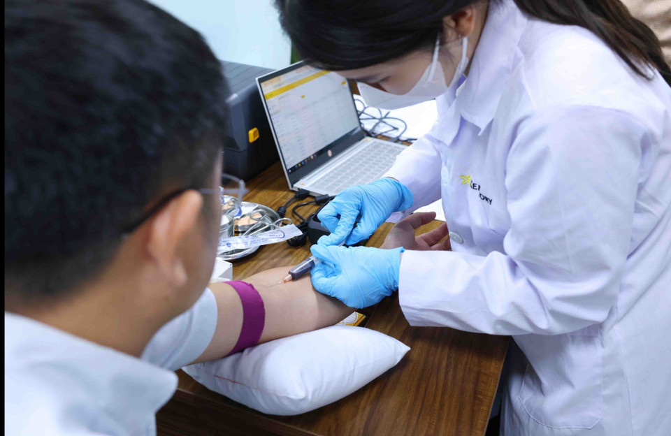 Người dân lấy mẫu sinh trắc học ADN để tích hợp vào cơ sở dữ liệu căn cước. (Ảnh: Phạm Kiên/TTXVN)