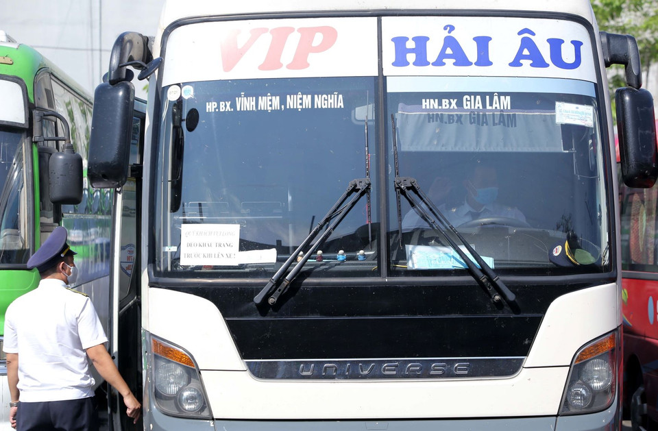 Lái xe và nhân viên bến Gia Lâm chấp hành nghiêm việc đeo khẩu trang phòng dịch. (Ảnh: Hoàng Hiếu/TTXVN)