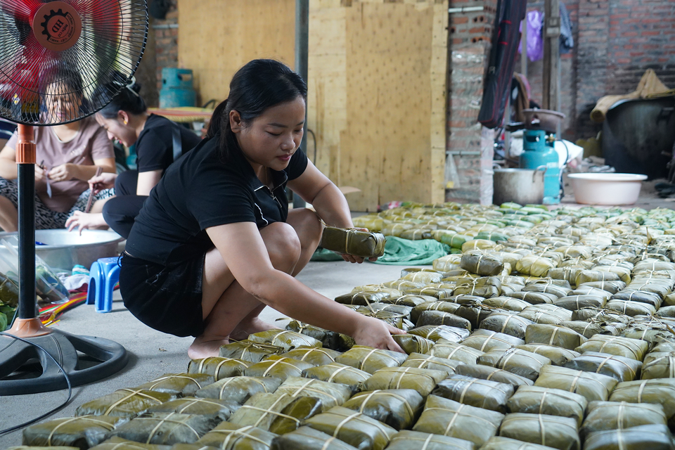 Người dân làng La Phù hy vọng những chiếc bánh chưng "của một đồng, công một nén" sẽ kịp thời đến tay bà con đồng bào. (Ảnh: Việt Anh/Vietnam+)
