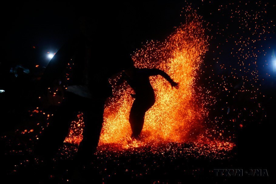 Không có bất cứ một vật dụng nào để lót cho đôi chân của những chàng trai Pà Thẻn khi nhảy lửa (Tuyên Quang, 2023).(Ảnh: Nam Sương/TTXVN)