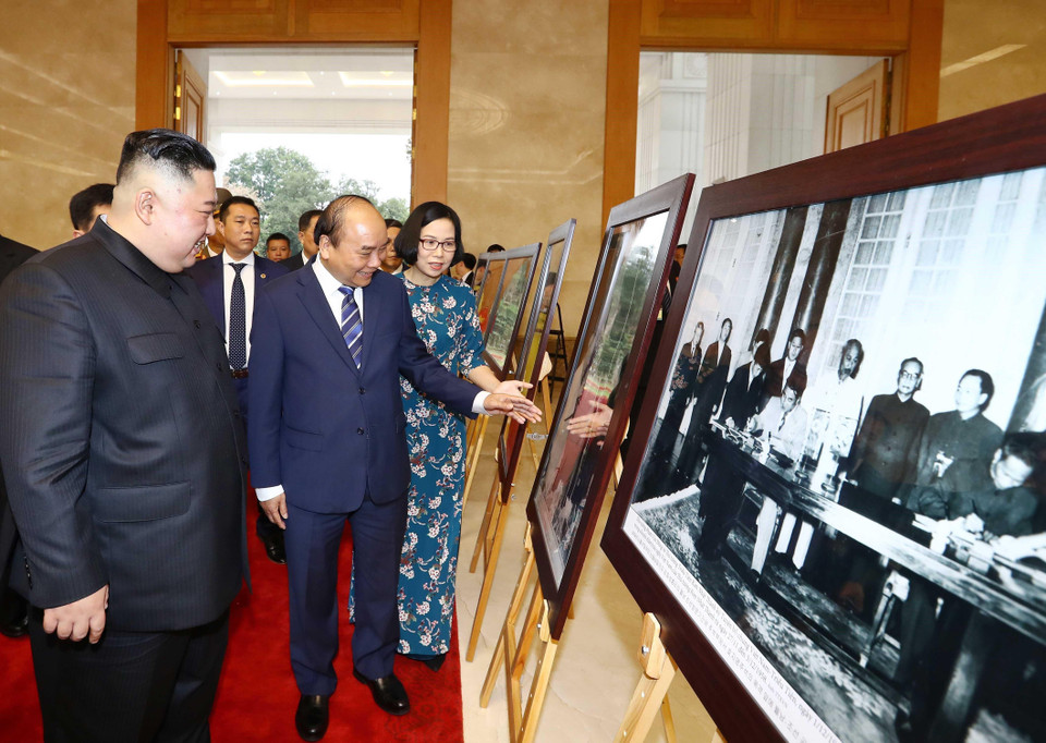 Thủ tướng Nguyễn Xuân Phúc giới thiệu với Chủ tịch Triều Tiên Kim Jong-un những bức ảnh tiêu biểu về quan hệ giữa hai nước trong 69 năm qua, kể từ ngày thiết lập quan hệ ngoại giao 31/1/1950, do các phóng viên ảnh của TTXVN chụp. (Ảnh: Thống Nhất/TTXVN)