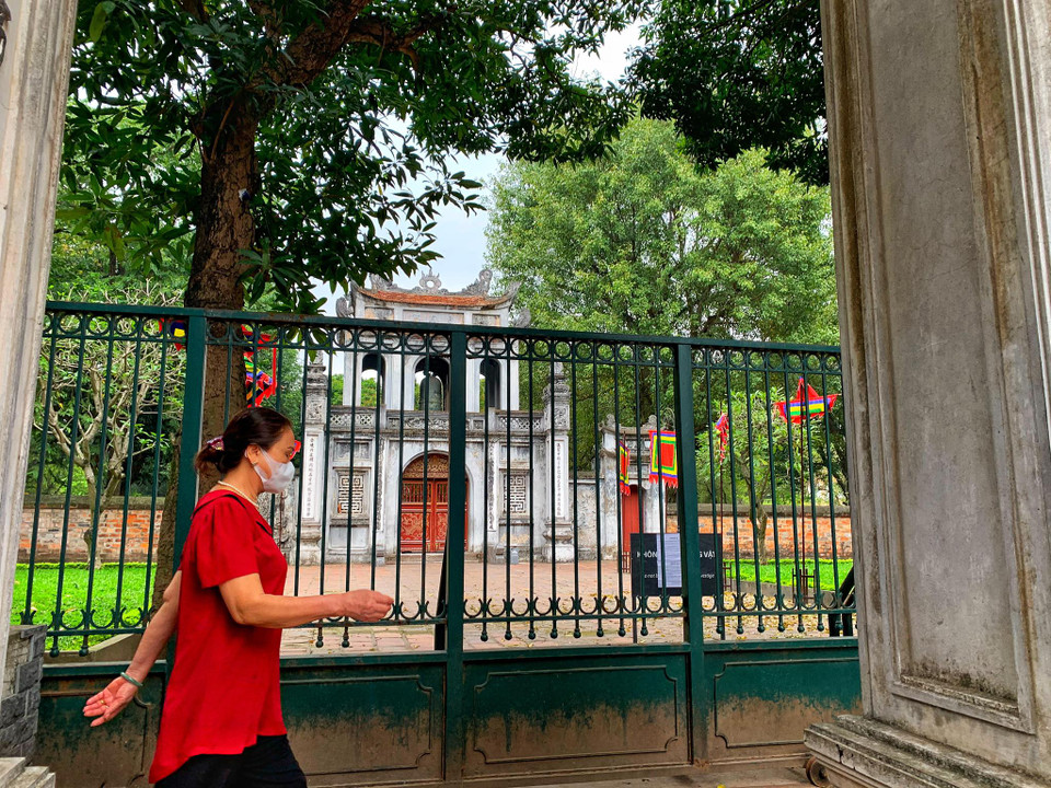 Những người dân thường ngày vẫn có thể đi bộ thể dục xung quanh khu vườn của Văn Miếu thì nay di tích đóng cửa, không còn lối vào. (Ảnh: Mai Mai/Vietnam+)