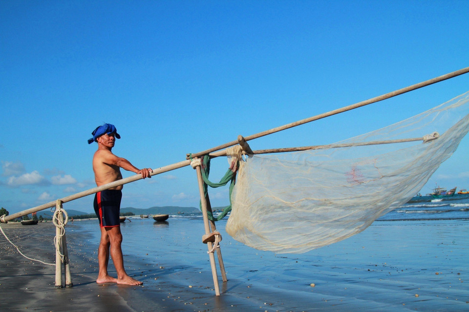Ông Nguyễn Nương, năm nay 65 tuổi, ở thôn Trung Vũ, xã Cảnh Dương, gắn bó với vùng biển quê nhà từ năm mới đôi mươi cho biết ruốc ít hay nhiều là phụ thuộc vào con nước theo ngày Trăng. (Ảnh: Xuân Mai/Vietnam+)