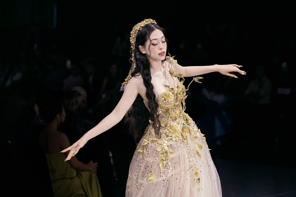 Á hậu Phương Nga đảm nhiệm vị trí kết màn cho bộ sưu tập. Cô hóa thân thành nữ thần Mặt Trời trong thiết kế bằng voan lưới đính kết kim tuyến và đá quý. Bộ váy được đính kết họa tiết hoa lá tỉ mỉ, những nhánh hoa được thêu 3D tạo nên sự uyển chuyển sinh động. (Ảnh: CTV/Vietnam+)