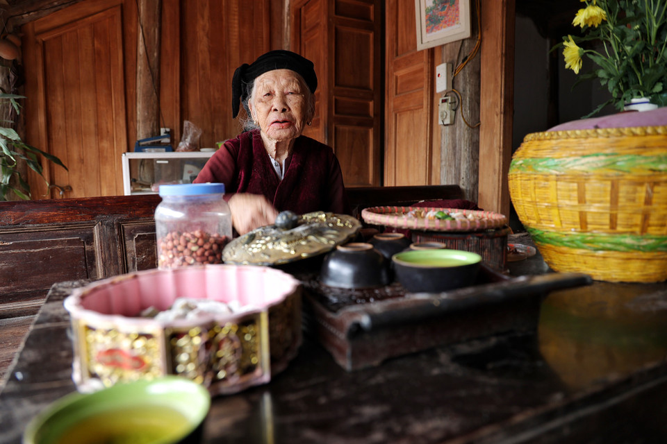 Cụ Hậu cho biết, hơn chục năm trước, dự án của Nhật Bản đã tài trợ các gia đình trong làng bảo tồn, duy tu những căn nhà cổ xuống cấp. Khách đến nhà, không phân biệt thân sơ đều được cụ Hậu mời thưởng trà, chè lam... hay những đặc sản của vùng đất hai Vua. (Ảnh: Xuân Mai/Vietnam+)