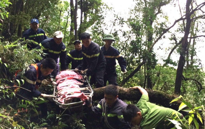 Những nỗ lực của lực lượng cứu hộ đưa thi thể nạn nhân ra khỏi khu vực gặp nạn. (Ảnh: Hương Thu/TTXVN) 