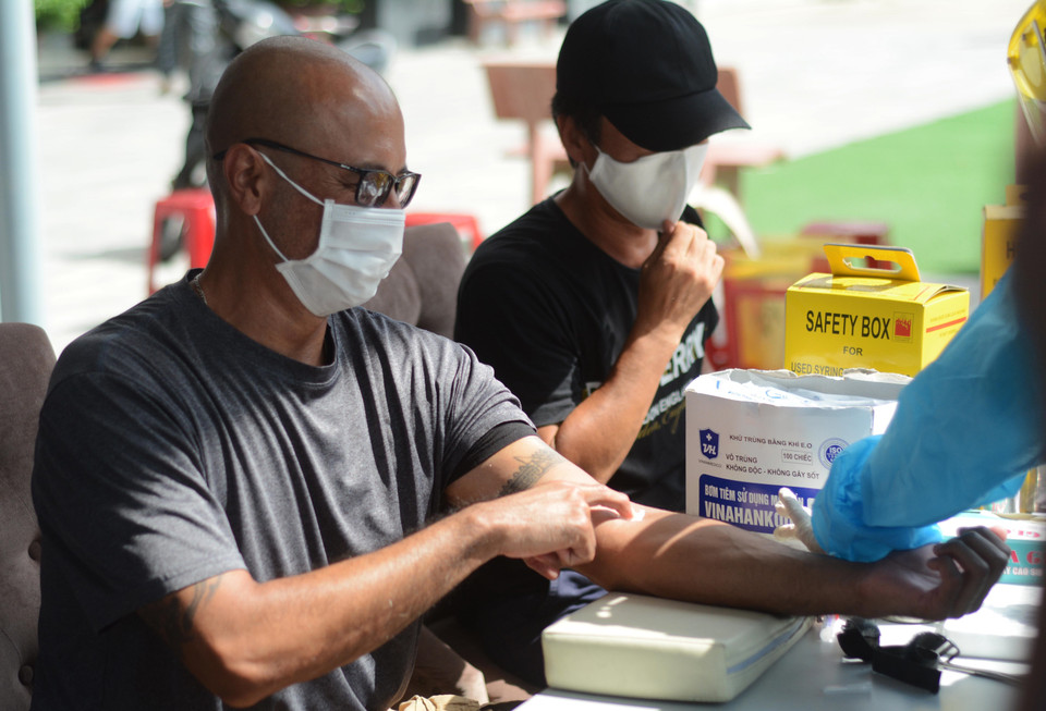 Nhân viện y tế lấy máu xét nghiệm của người nước ngoài. (Ảnh: Văn Dũng/TTXVN)