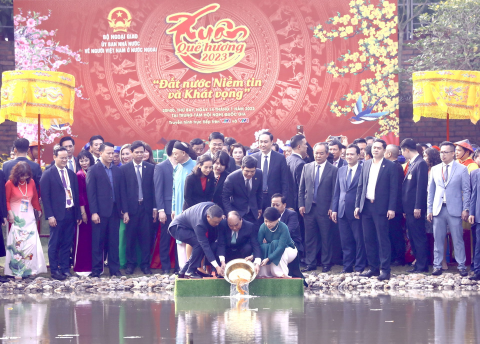 Chủ tịch nước Nguyễn Xuân Phúc và Phu nhân cùng các đại biểu kiều bào thả cá chép tiễn ông Công, ông Táo theo phong tục truyền thống. (Ảnh: Lâm Khánh/TTXVN)