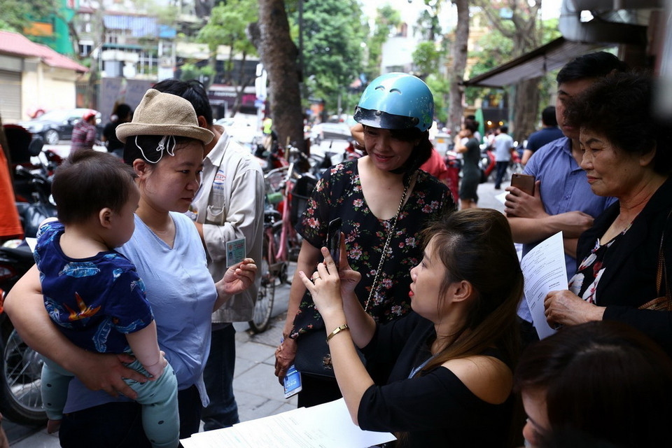 Điểm giao dịch của Viettel trên phố Phan Chu Trinh quá tải, khách hàng phải đăng ký bên ngoài điểm giao dịch. (Ảnh: Minh Quyết/TTXVN)