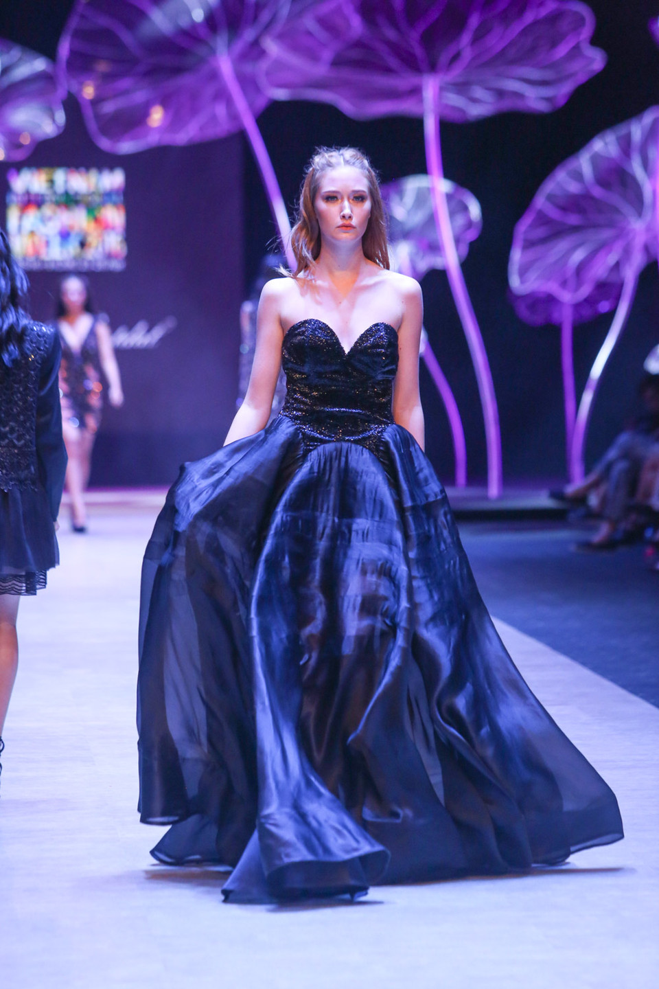 Nhà thiết kế Nina Naustdal sinh ra tại Oslo, Na Uy và mang trong mình tình yêu đối với thời trang ngay từ nhỏ khi được chứng kiến bà mình là một thợ may làm các công việc liên quan đến vải vóc, quần áo.