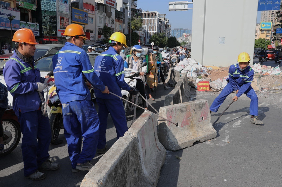 Công nhân đang mở lối đi lên đường vành đai 2 đoạn phía Ngã Tư Sở. (Ảnh: Danh Lam/TTXVN)