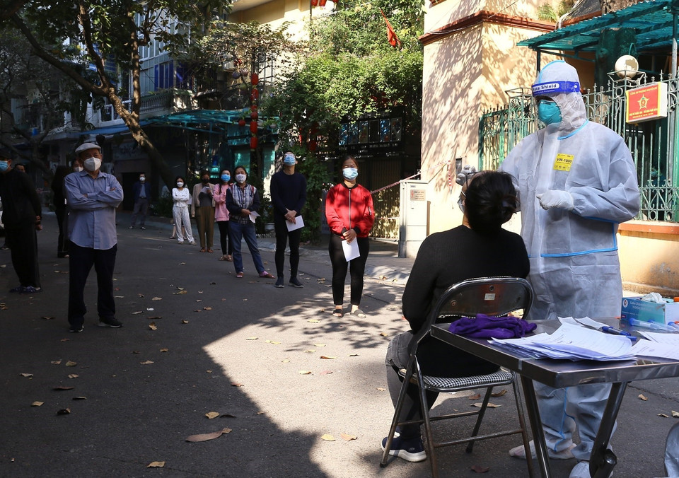 Người dân trong khu vực bị phong tỏa phố Đỗ Hành được lấy mẫu xét nghiệm sàng lọc COVID-19. (Ảnh: Hoàng Hiếu/TTXVN)