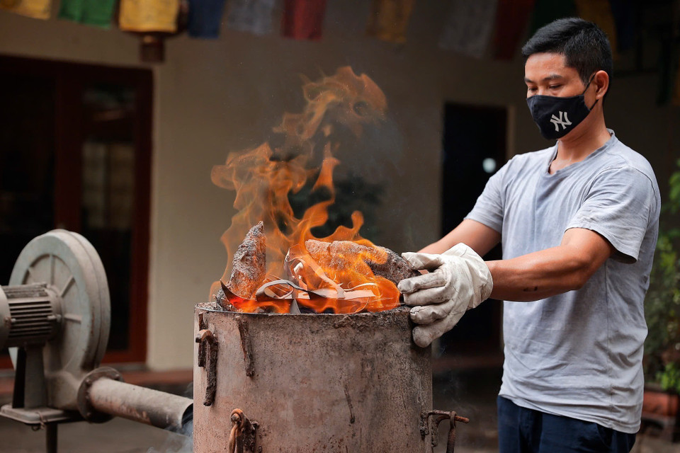 Người thợ chuẩn bị lò để nấu chảy đồng nguyên chất trước khi đúc. (Ảnh: Minh Quyết/TTXVN)