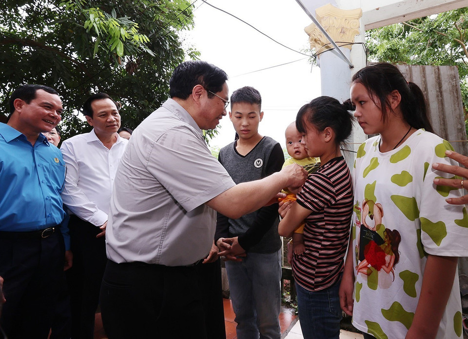 Thủ tướng Phạm Minh Chính thăm, tặng quà cho công nhân đang ở trọ tại thôn An Định, xã Tiền Phong, huyện Yên Dũng.(Ảnh: Dương Giang/TTXVN)