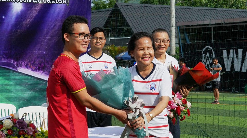 Phó Quốc vụ khanh Bộ Ngoại giao và Hợp tác Quốc tế Vương quốc Campuchia, bà Tuot Panha tặng hoa lưu niệm đội Đại sứ quán Việt Nam.